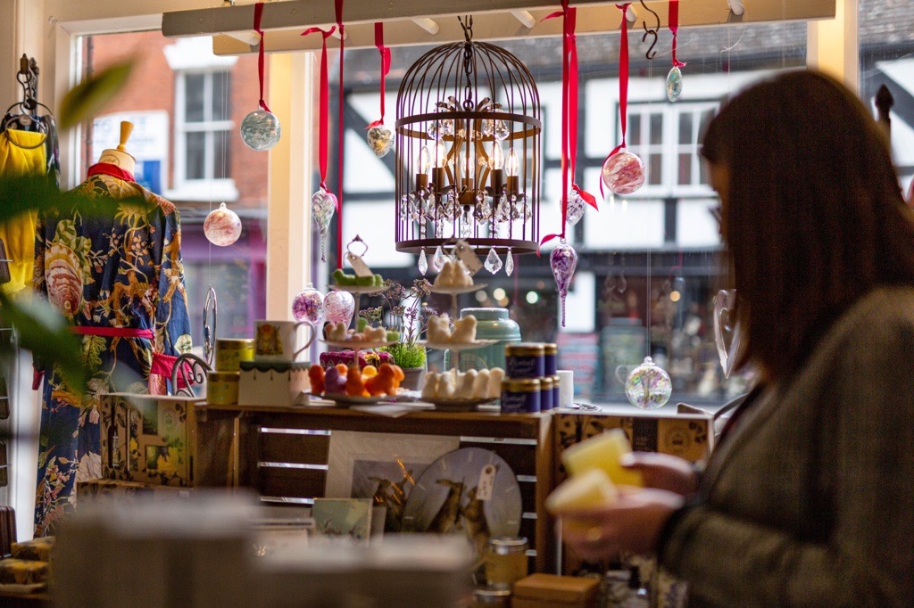 Lady looking at gifts in the Candle Tree Shop in Gloucester